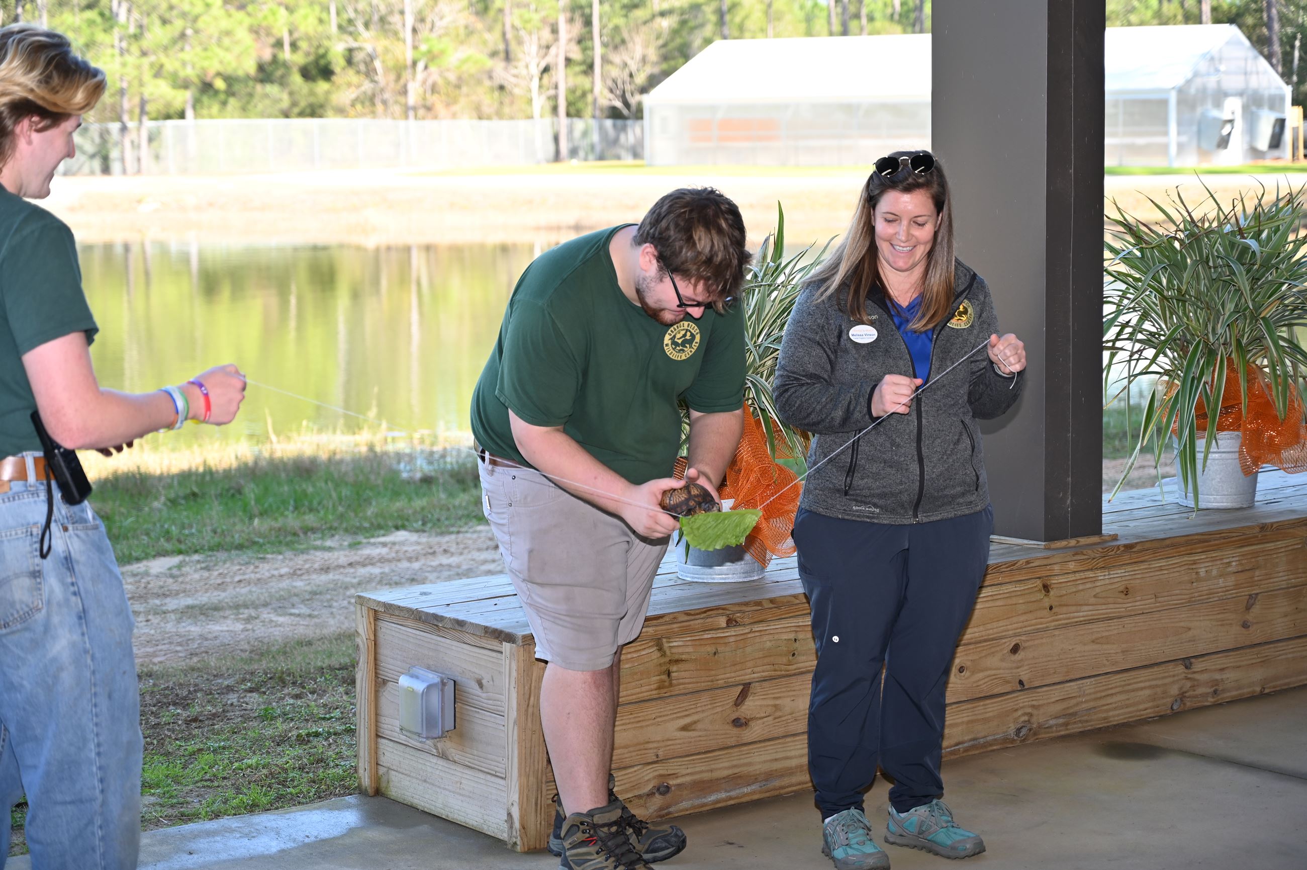 Wildlife Center staff hold Crush, the resident box turtle, during the ribbon-cutting ceremony